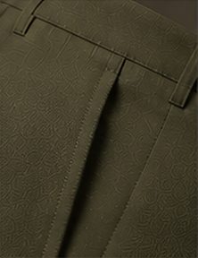 Calça Alfaiataria Signature na cor verde oliva, detalhe do bolso